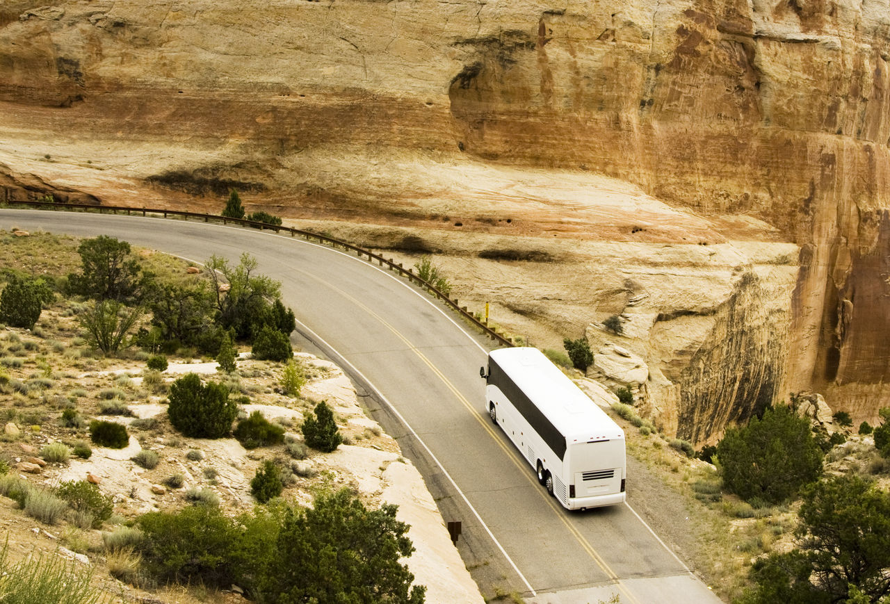 A tour bus drives through the scenery along the Rim Rock Drive in Colorado National Park.