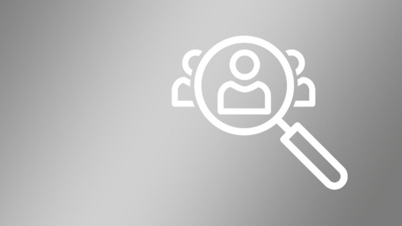 Graphic of a magnifying glass moving over abstract persons