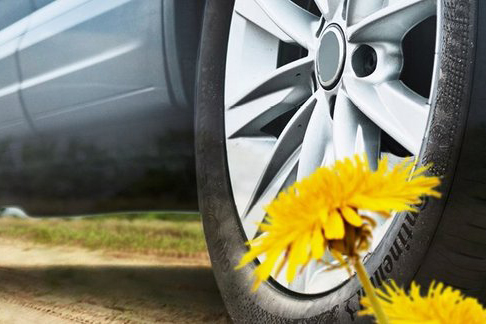 A composition of two hands scraping milk out of a jar, a tractor in a field and a car with a dandelion in front of it