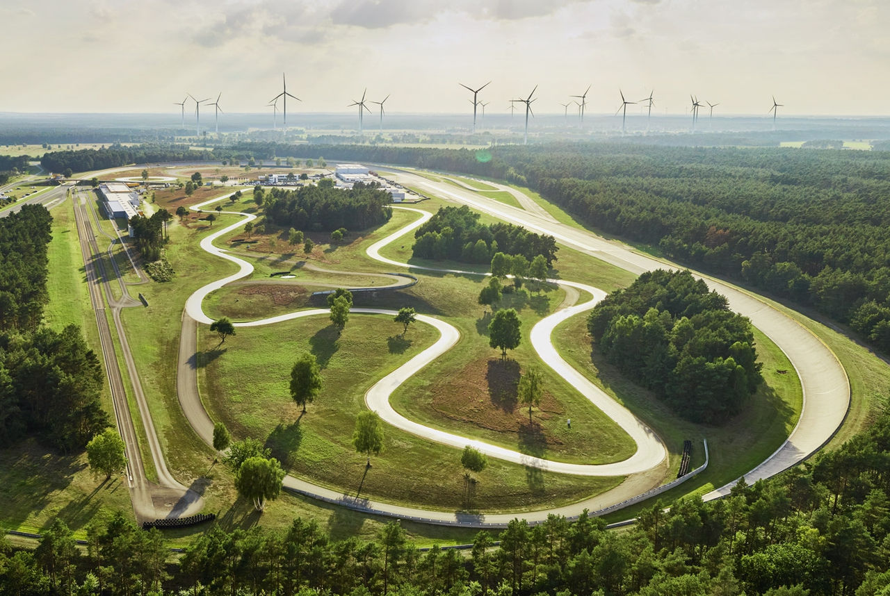 Aerial view of a route through green fields