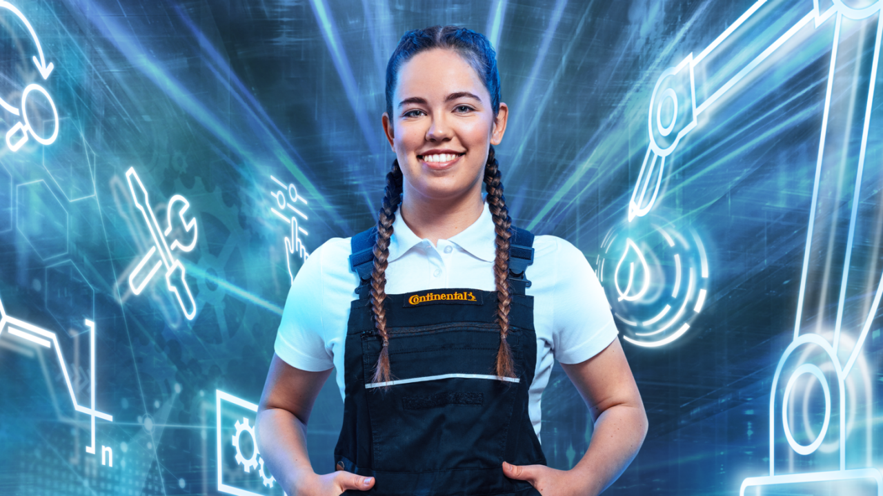 A smiling woman with braided hair, wearing a white polo shirt and black overalls with a "Continental" logo
