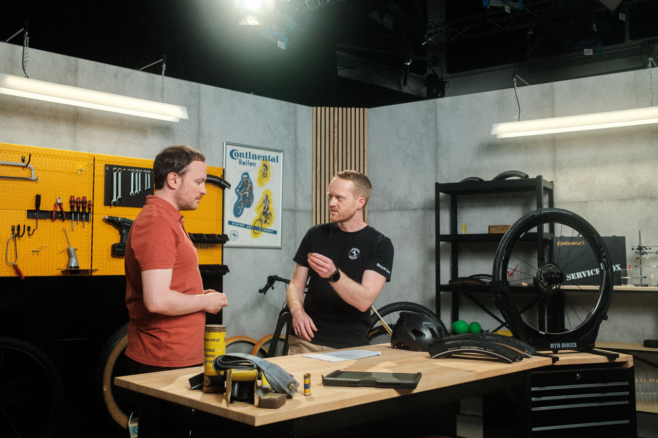 The Continental Tires Garage Studio with Oliver holding up a €2 coin