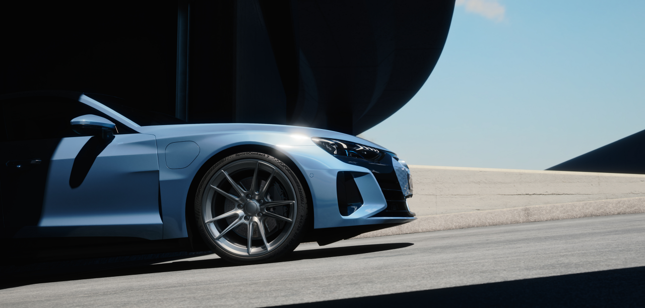 A blue sports car driving on a road