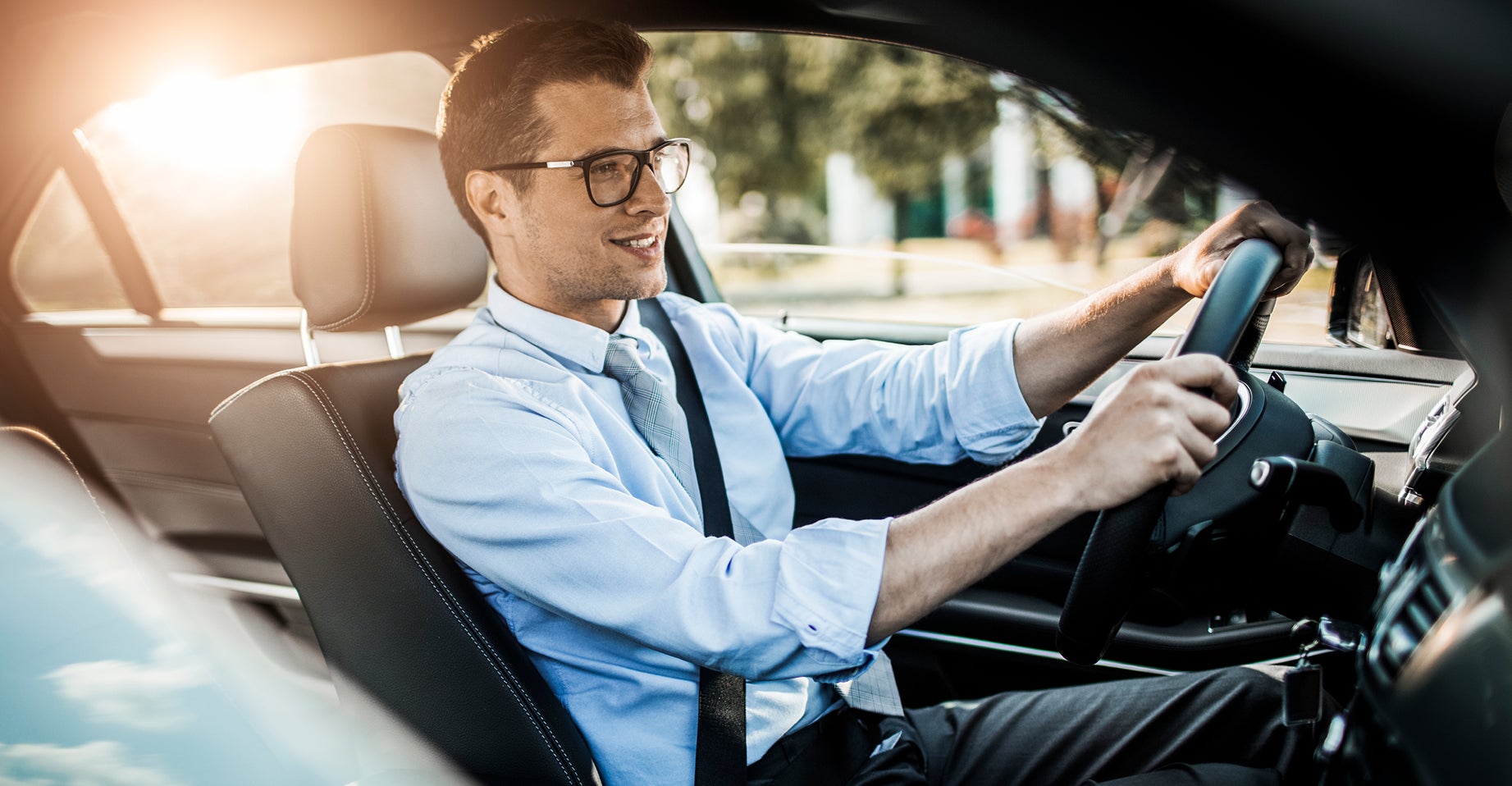 Close up photo of a businessman driving a car