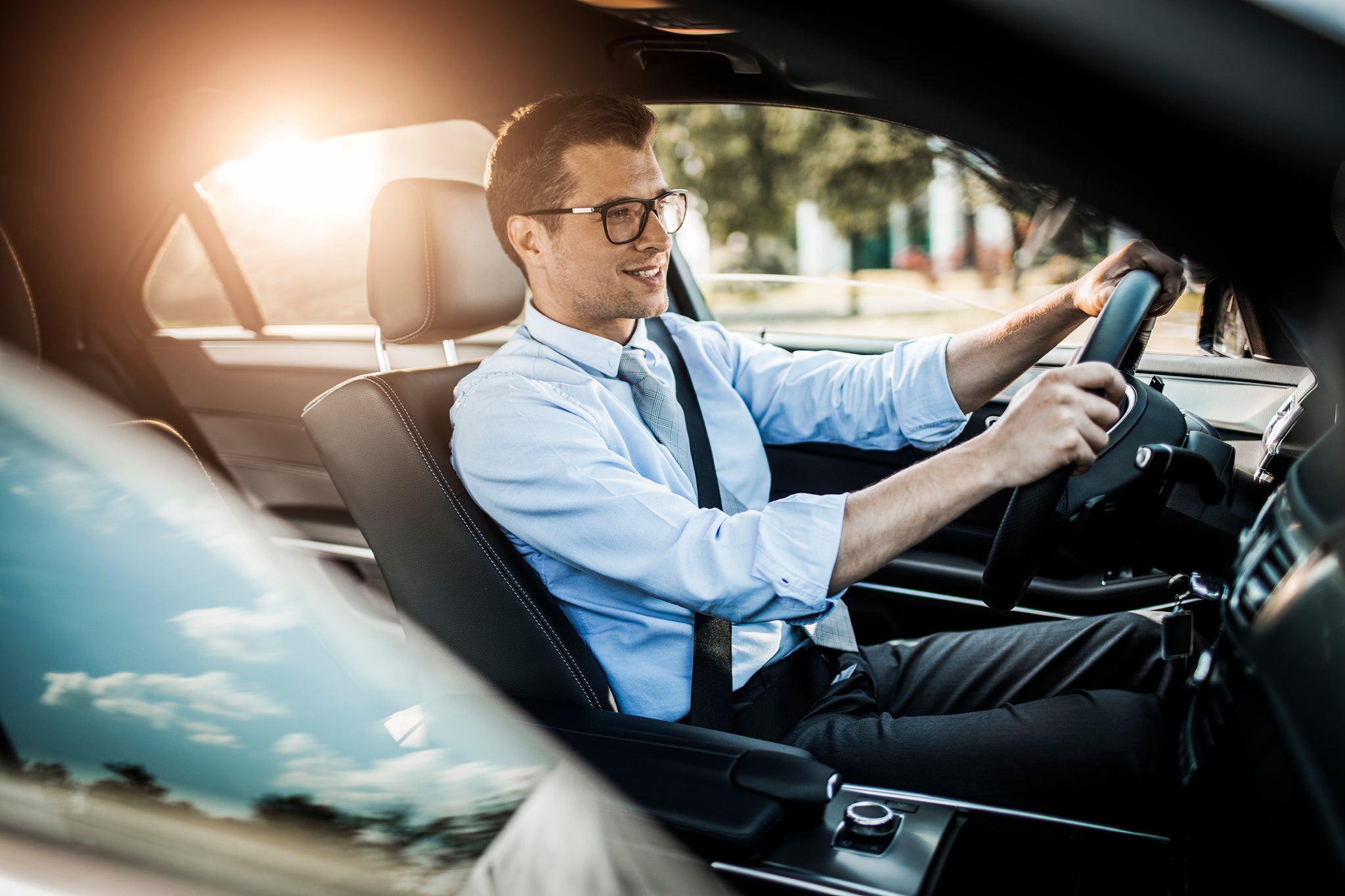 Close up photo of a businessman driving a car