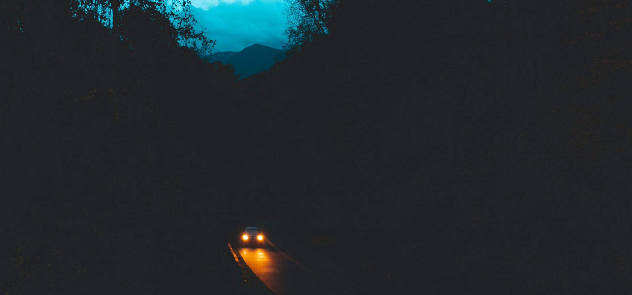 Car on a road by night