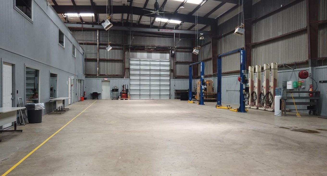 Interior of Building G at Uvalde Proving Grounds where skilled technicians service vehicles.