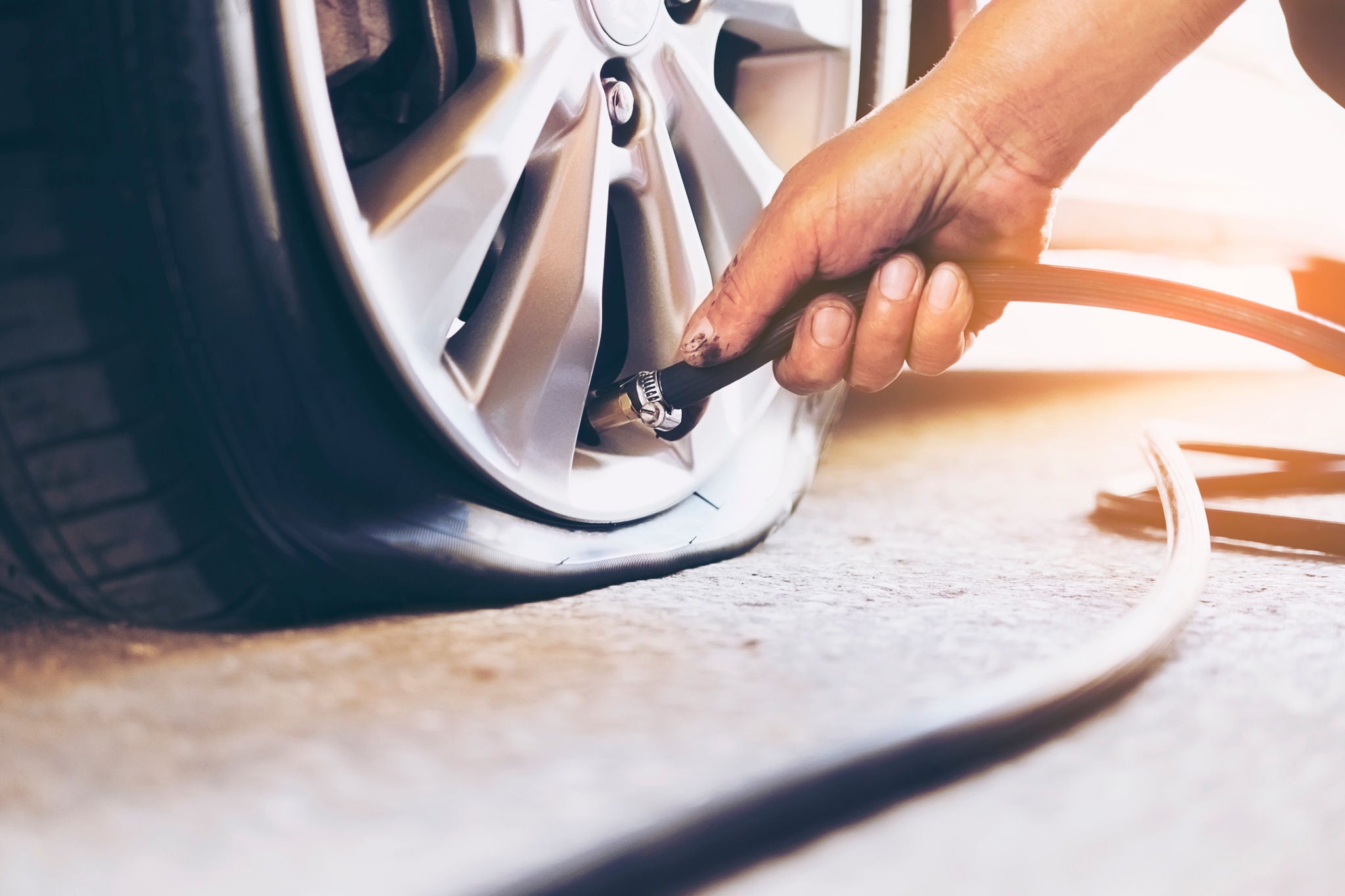 Technician is repairing car flat tire