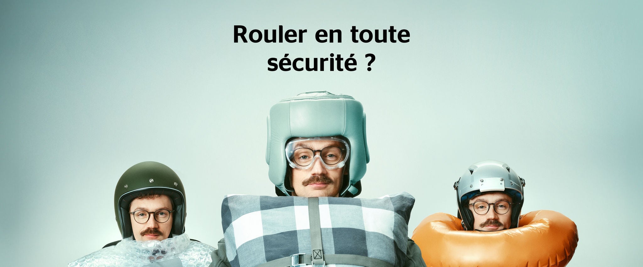 Un homme derrière le volant de sa voiture, entouré de différents dispositifs de sécurité (coussins, film à bulles, bouée). Titre : Rouler en toute sécurité ?