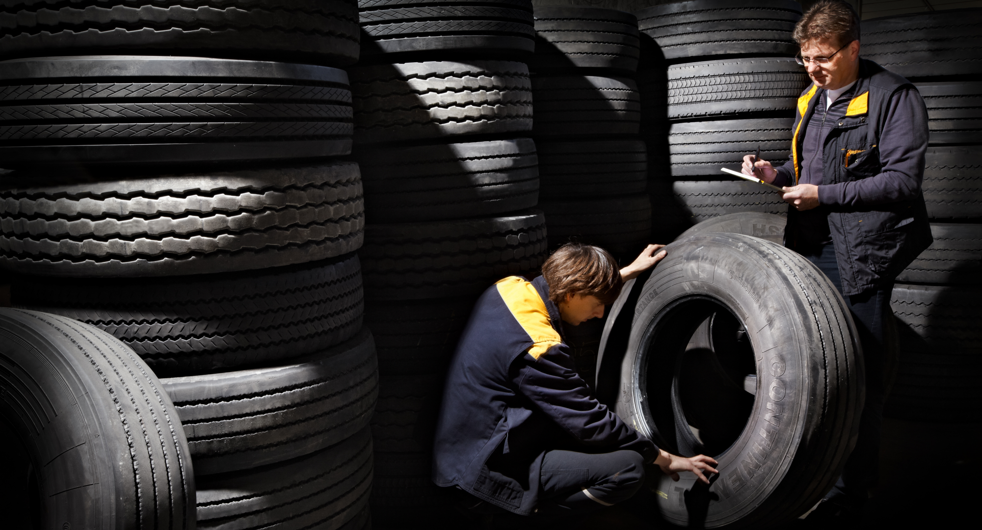 Workers storing tires
