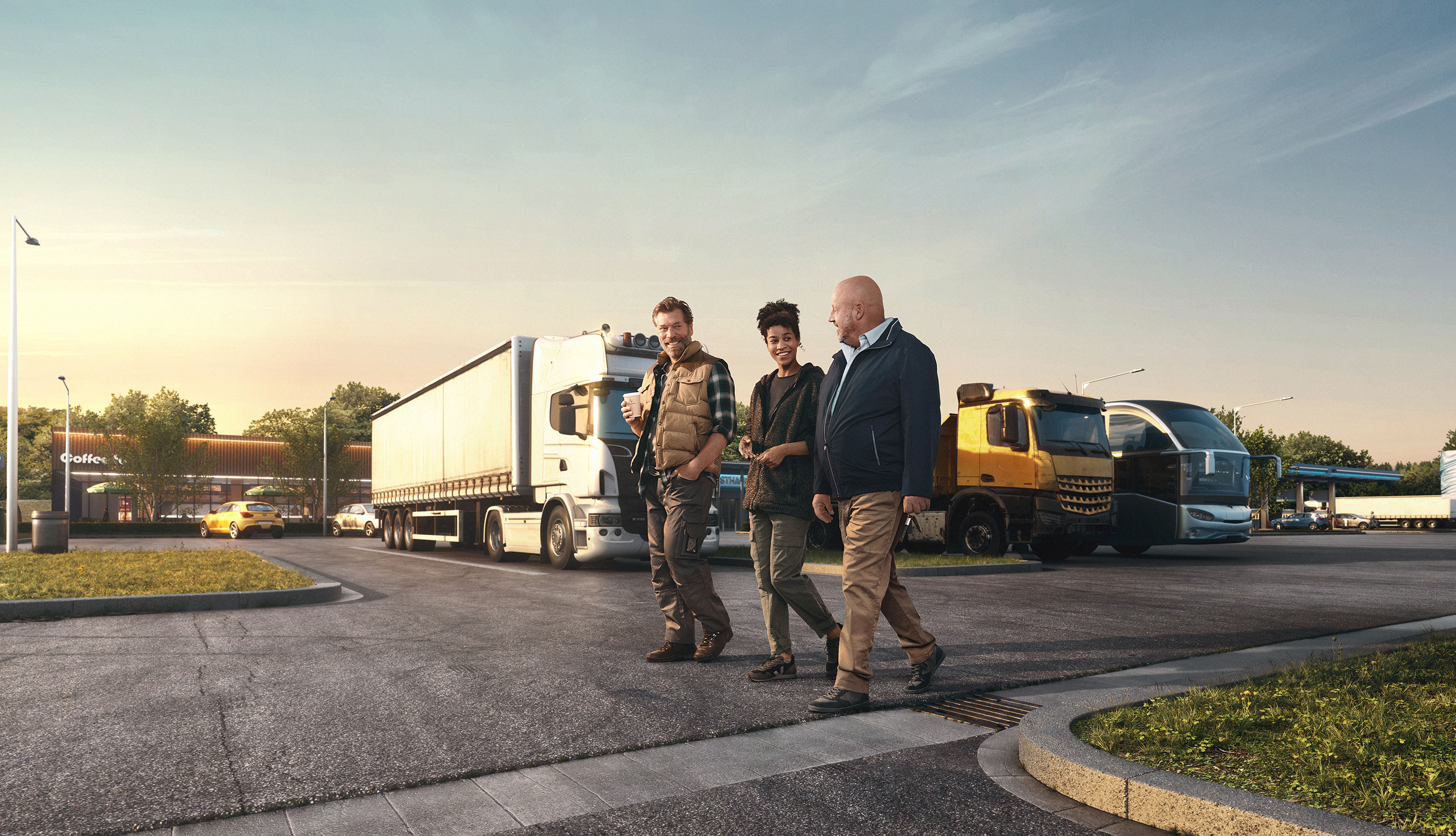 Three people walk in front of parked trucks