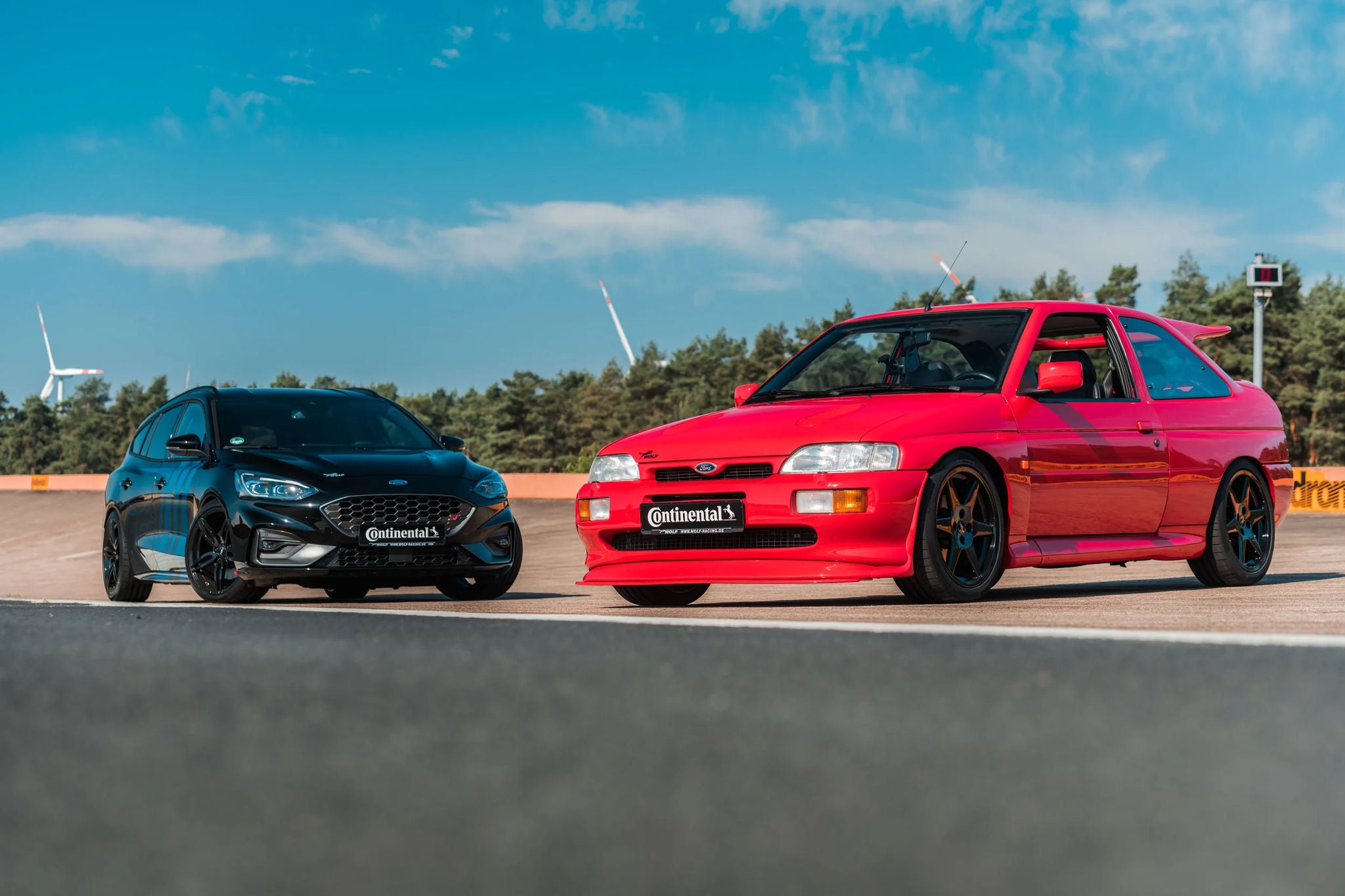 A red car next to a black car