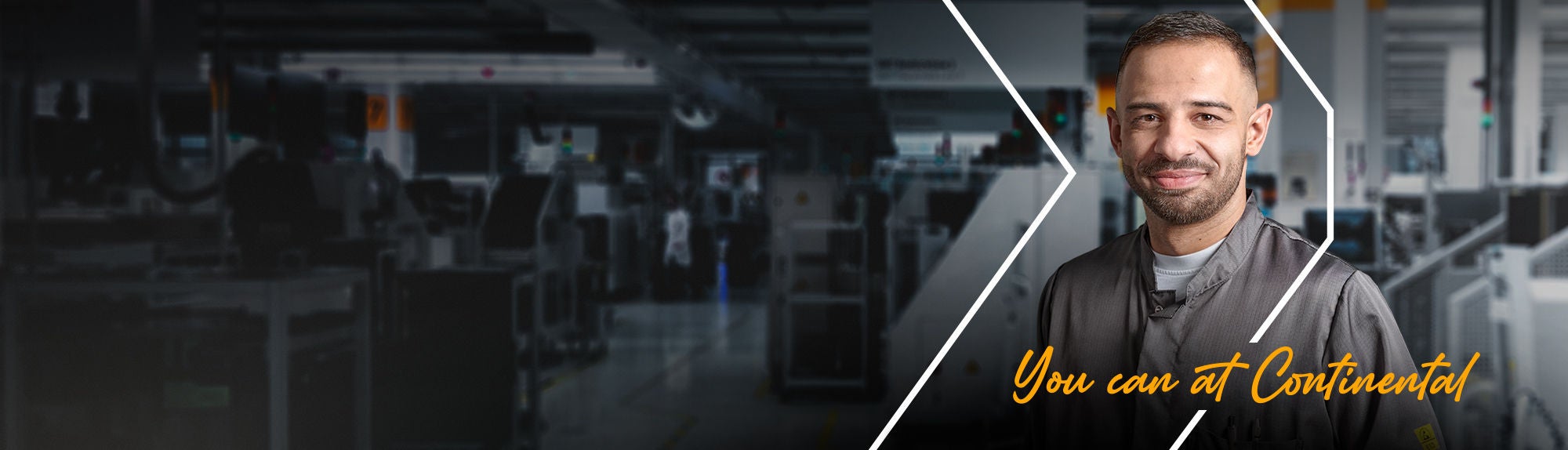 A man in work attire smiles at the camera inside an industrial or factory setting. The background is blurred, and yellow script text reads, "You can at Continental".