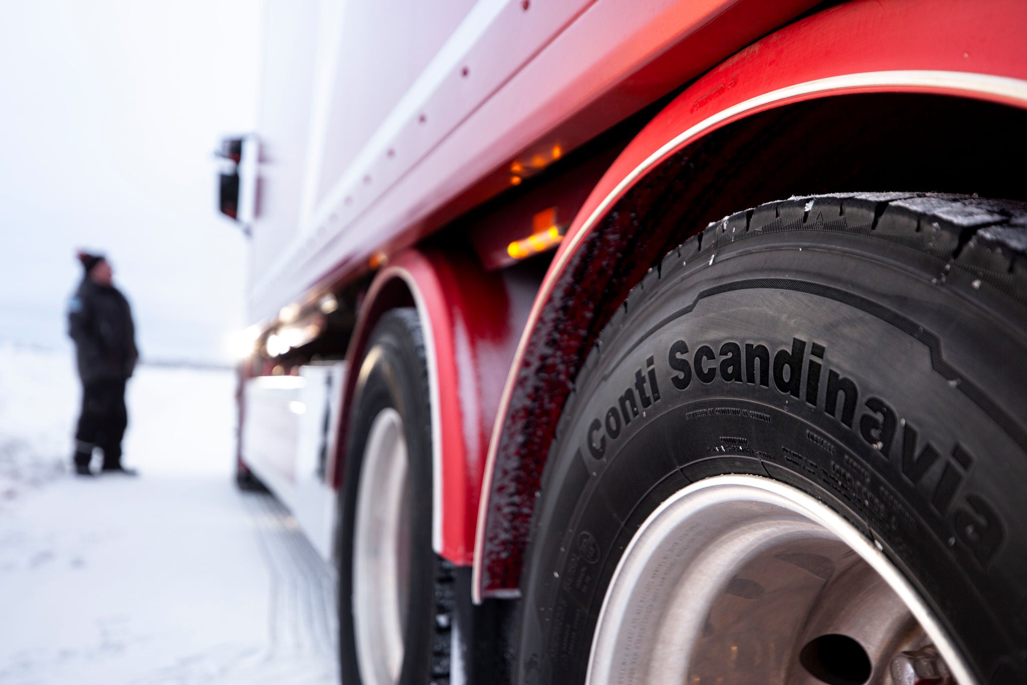 Man standing by Conti Scandinavia HD3 Tire in Snow