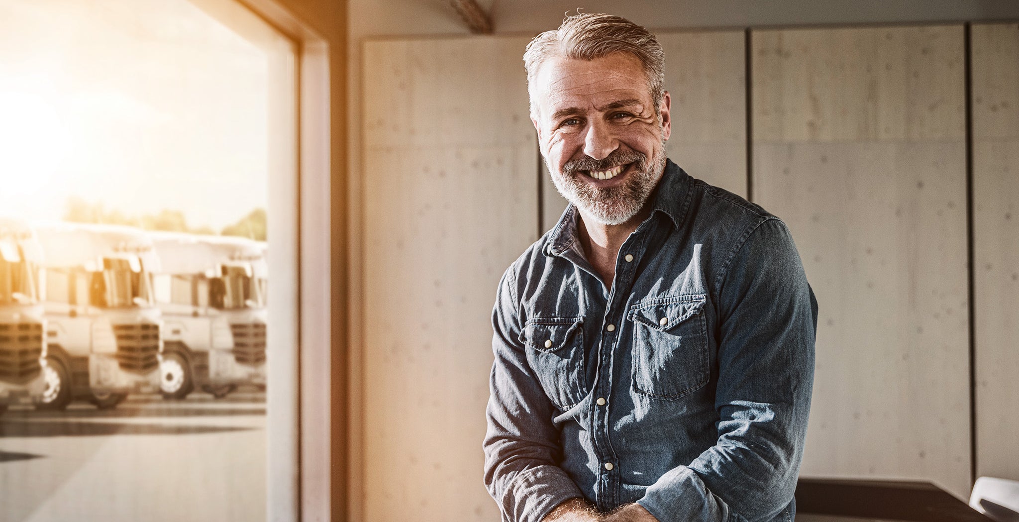 Portrait of smiling casual mature businessman in office