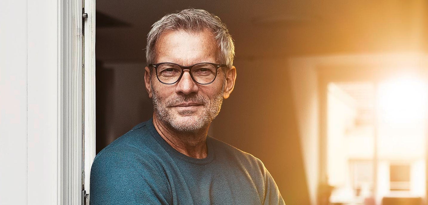 A fleet manager wearing glases at the door of his office