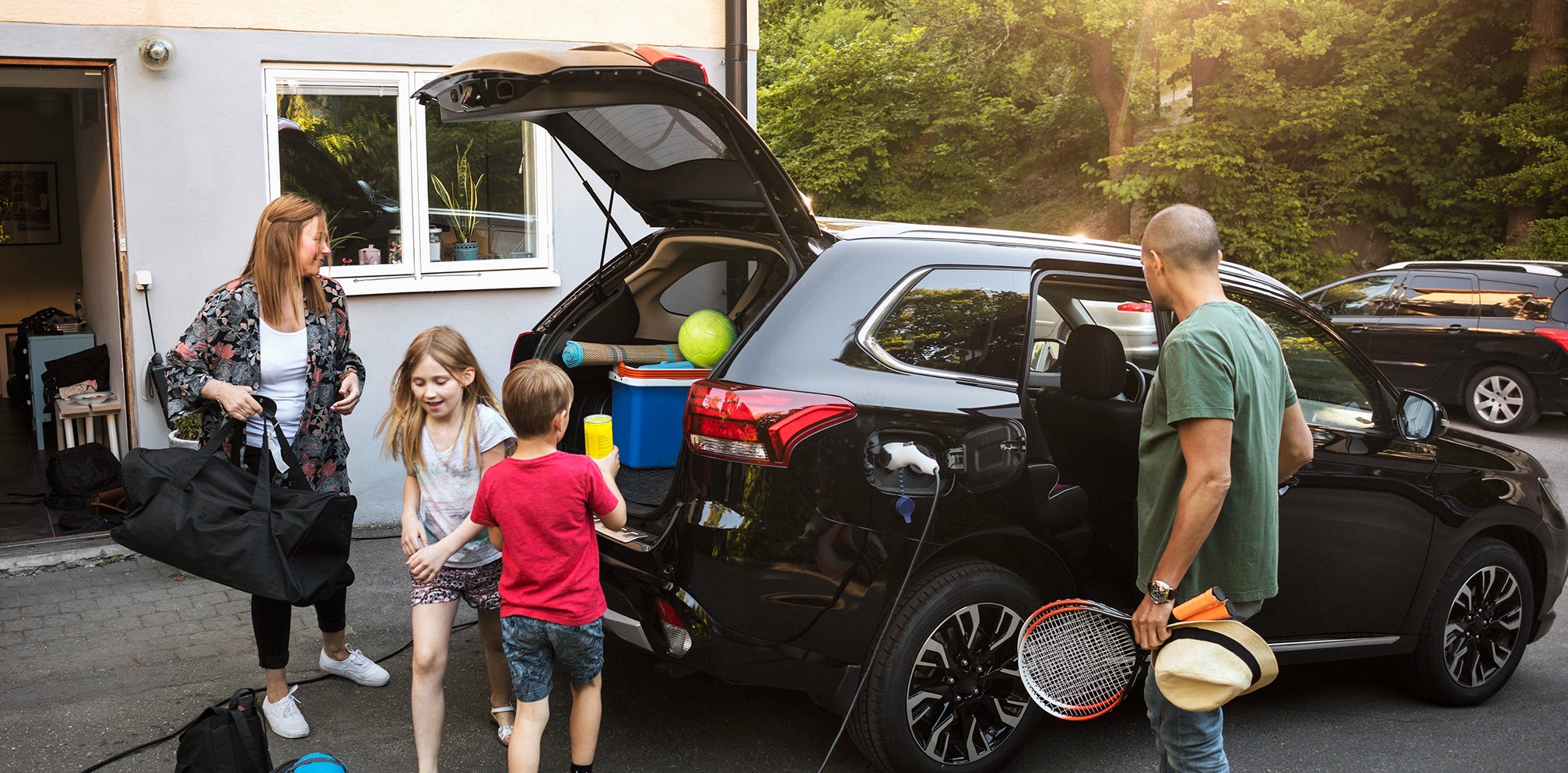 A family is loading their car, ready for holidays.