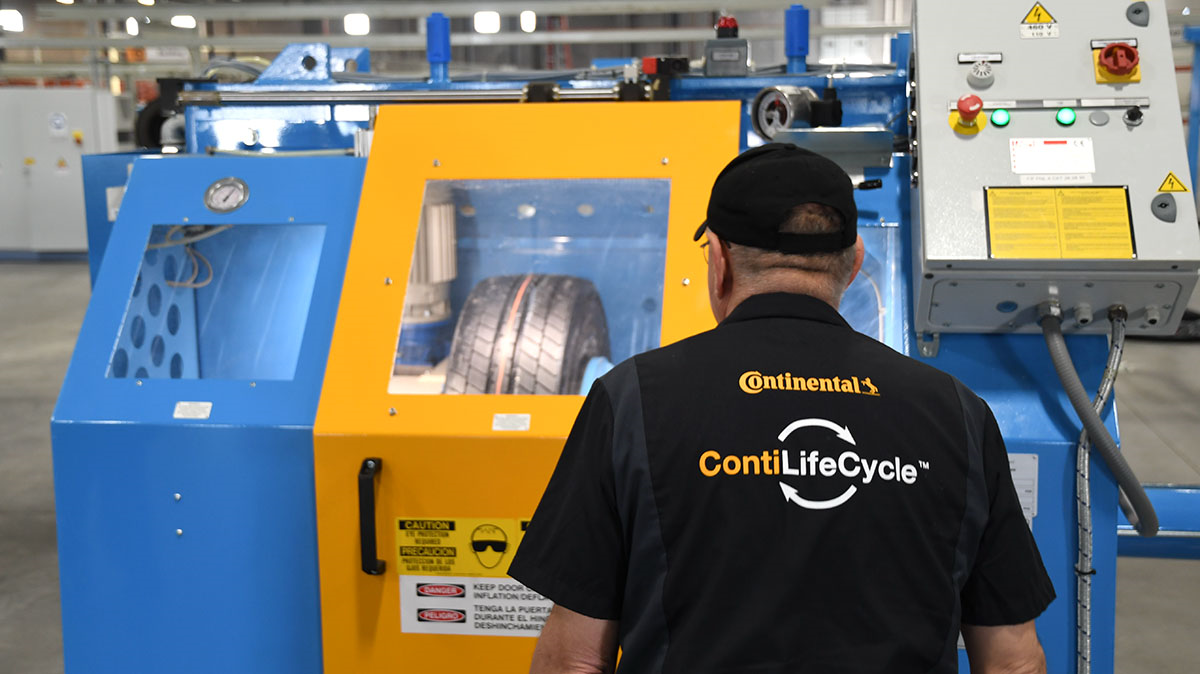 Retread equipment operator inspecting process.