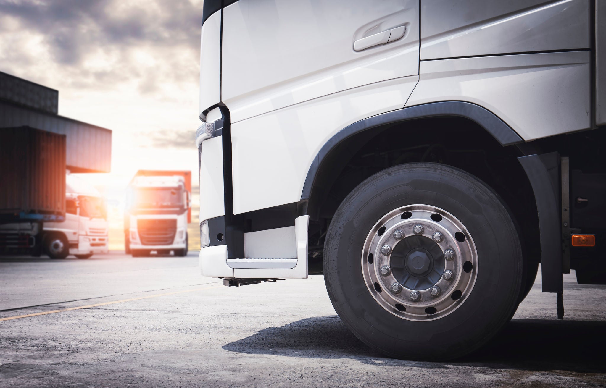 2063848811 Front of Semi Truck a Parking at the Warehouse. A Big Truck Wheels Tires. Cargo Freight Truck Transportation Logistics. ; Shutterstock ID 2063848811; purchase_order: -; job: -; client: -; other: -