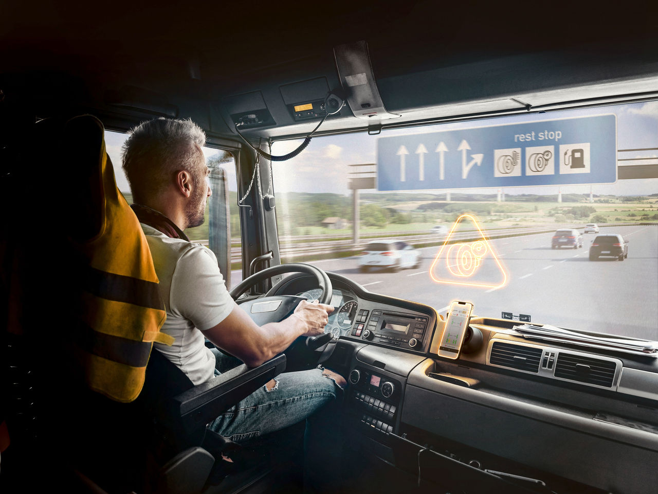 1298420747 Handsome driver at the wheel of a truck at work. Work of a lorry driver.