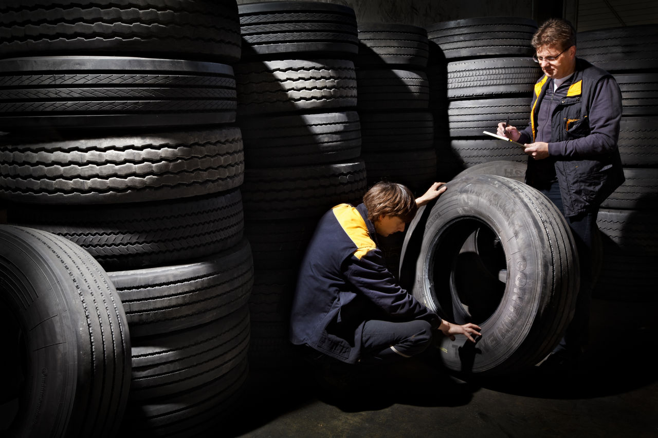 Workers storing tires