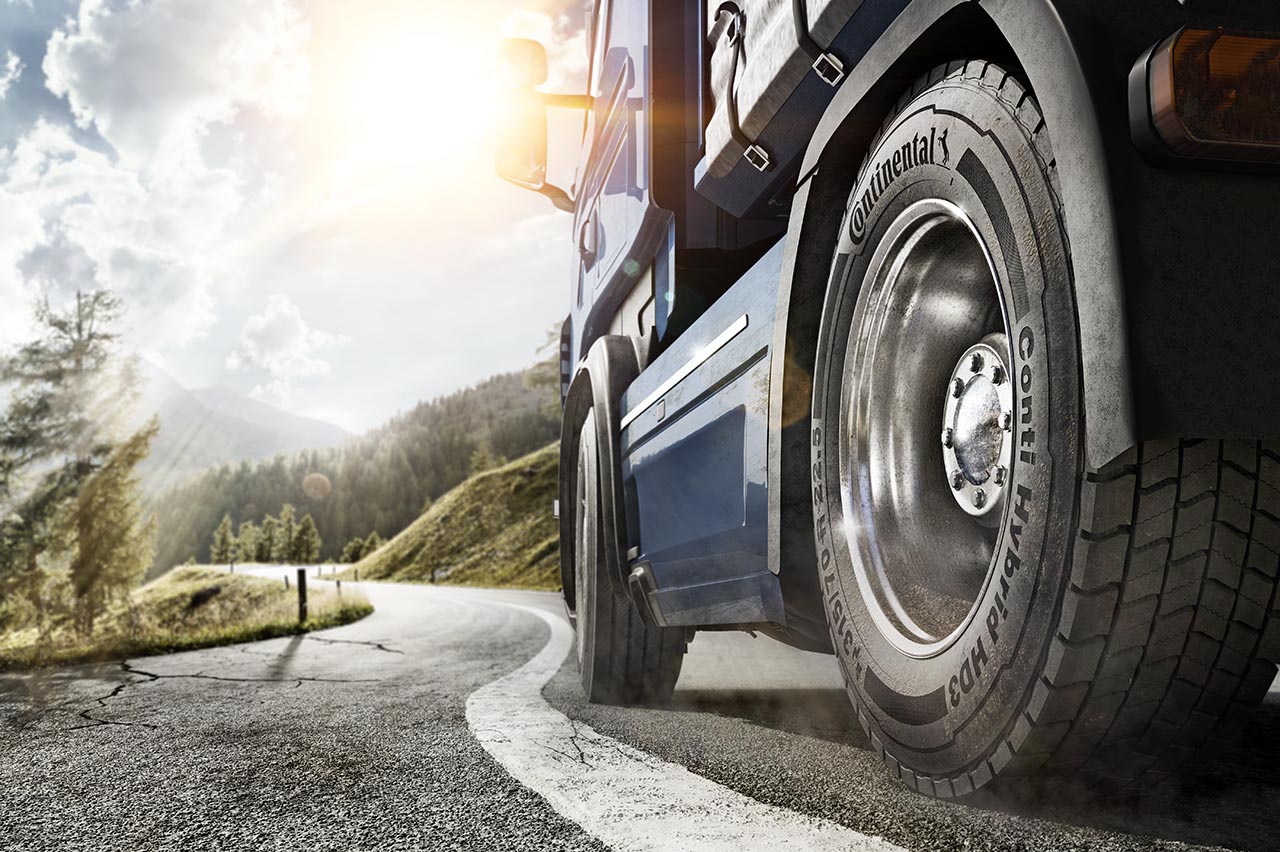 Truck tire on asphalt road along a forest in Austria.