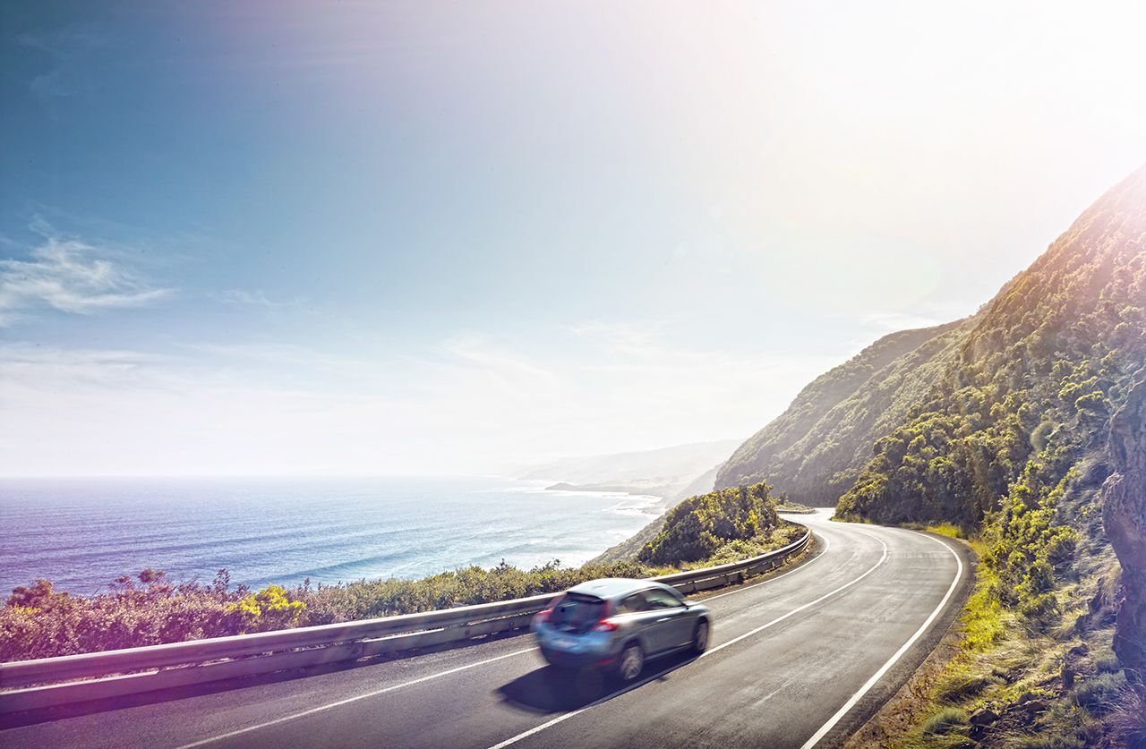 a car driving along the Great Ocean Road in Australia
