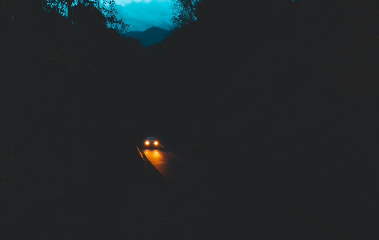 car on a road by night.