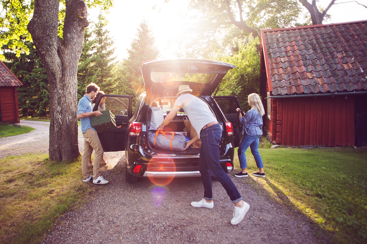 A familiy is prepairing their car for vacation.