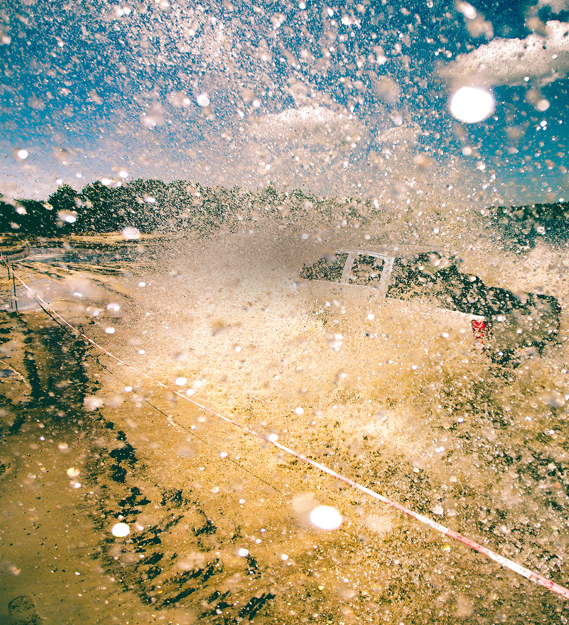 During a tire test a pick-up truck drives through a waterhole.