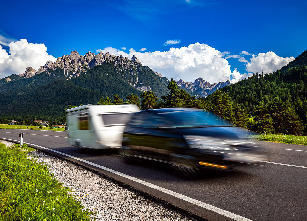 Family vacation travel, holiday trip in motorhome RV, Caravan car Vacation. Beautiful Nature Italy natural landscape Alps. Warning - authentic shooting there is a motion blur.