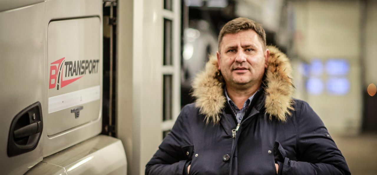 Director Slobodan Okosanović of BZ Transport, Slovenia, next to a truck.