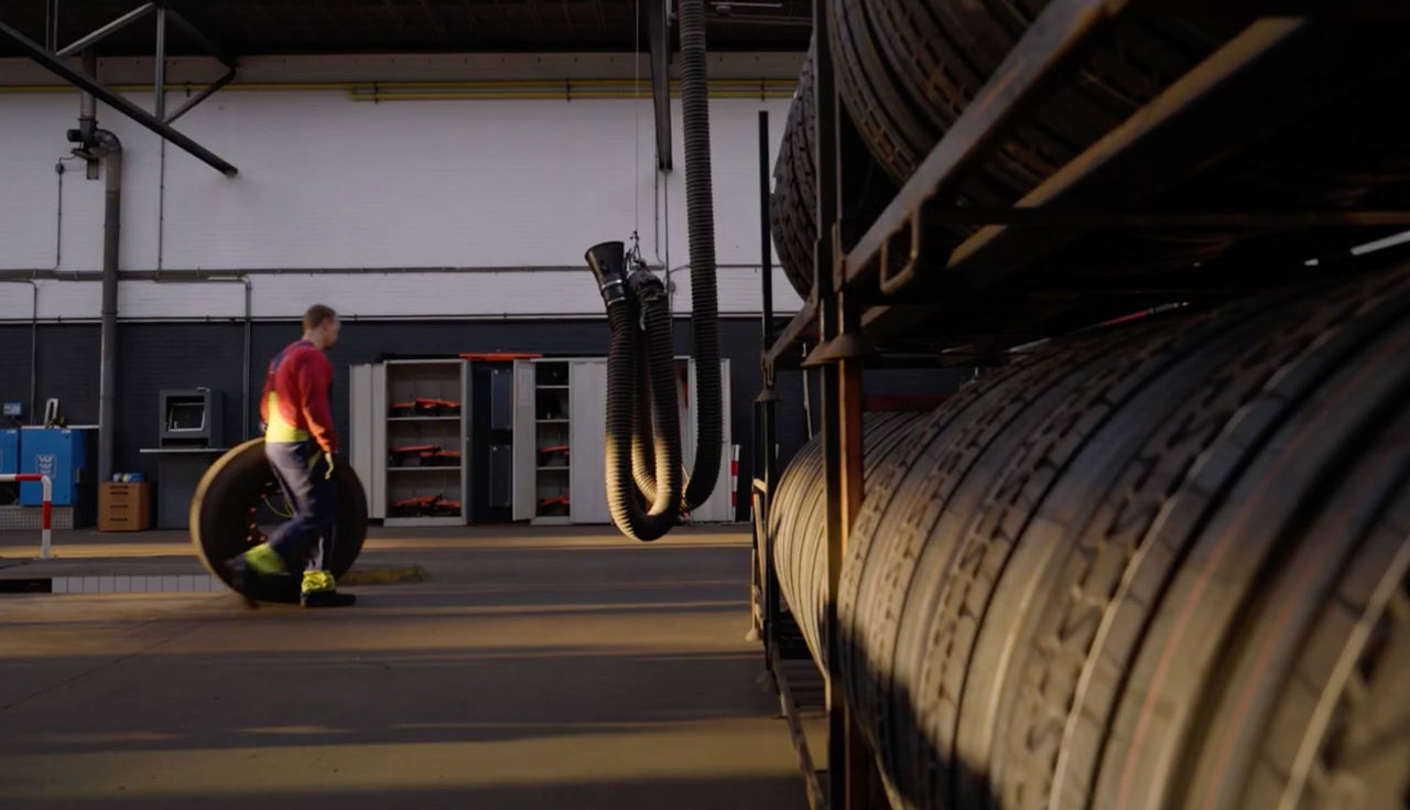 An employee storing truck tires