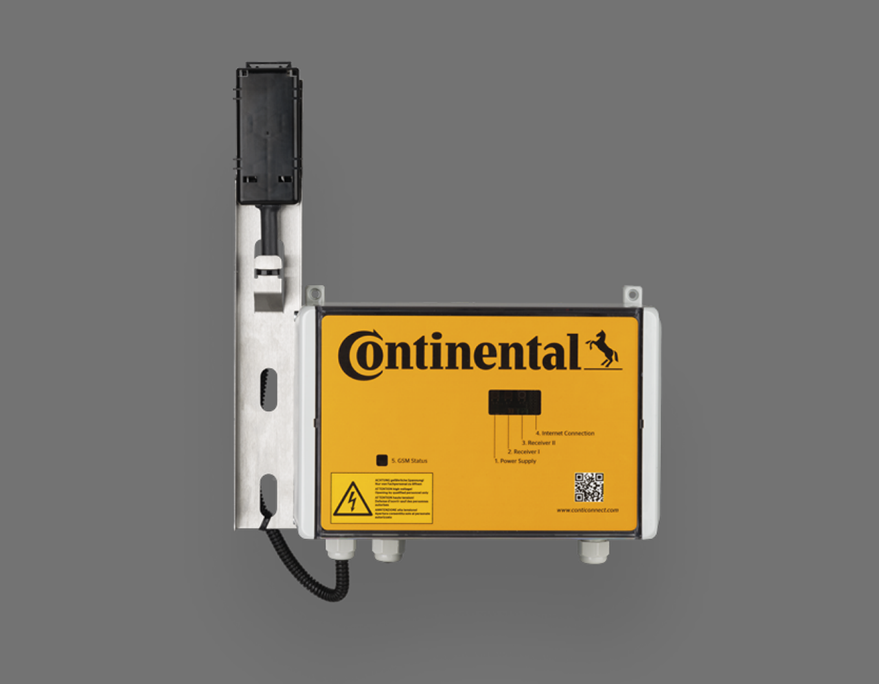 A rectangular yellow and black electronic device labeled “Continental” with a horse logo, mounted on a metal bracket, against a plain gray background. The device has labels, warnings, and a QR code on its front.