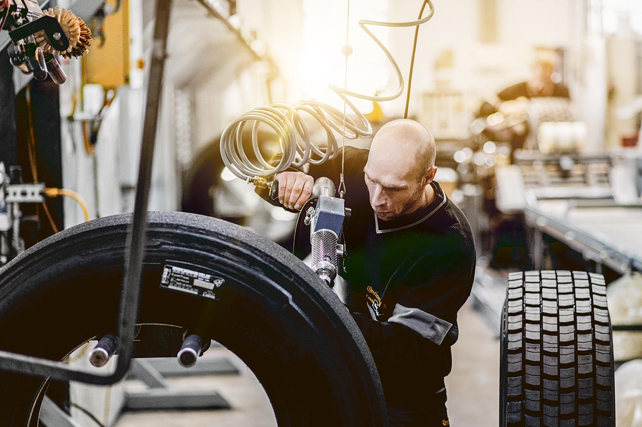 Mechanic preparing a tire for retreading 