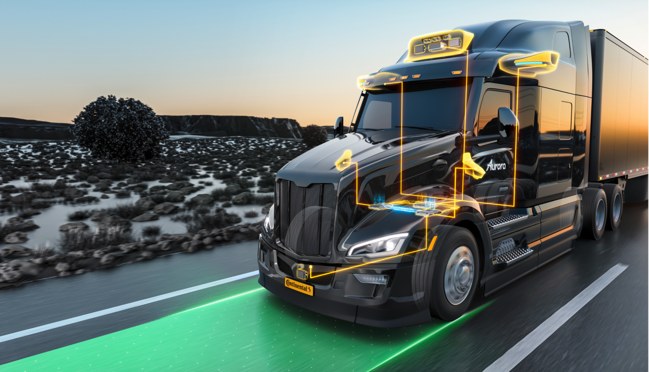 A truck with visible technology highlights is driving on a highway.