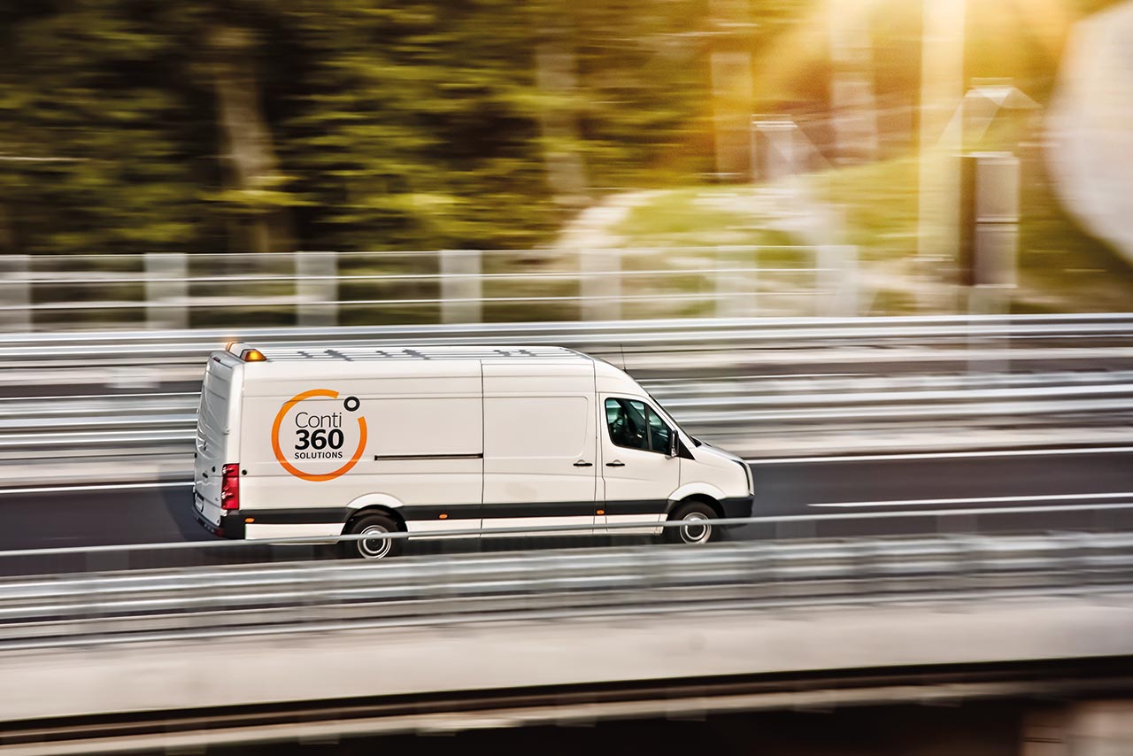 White delivery van in speed on highway.