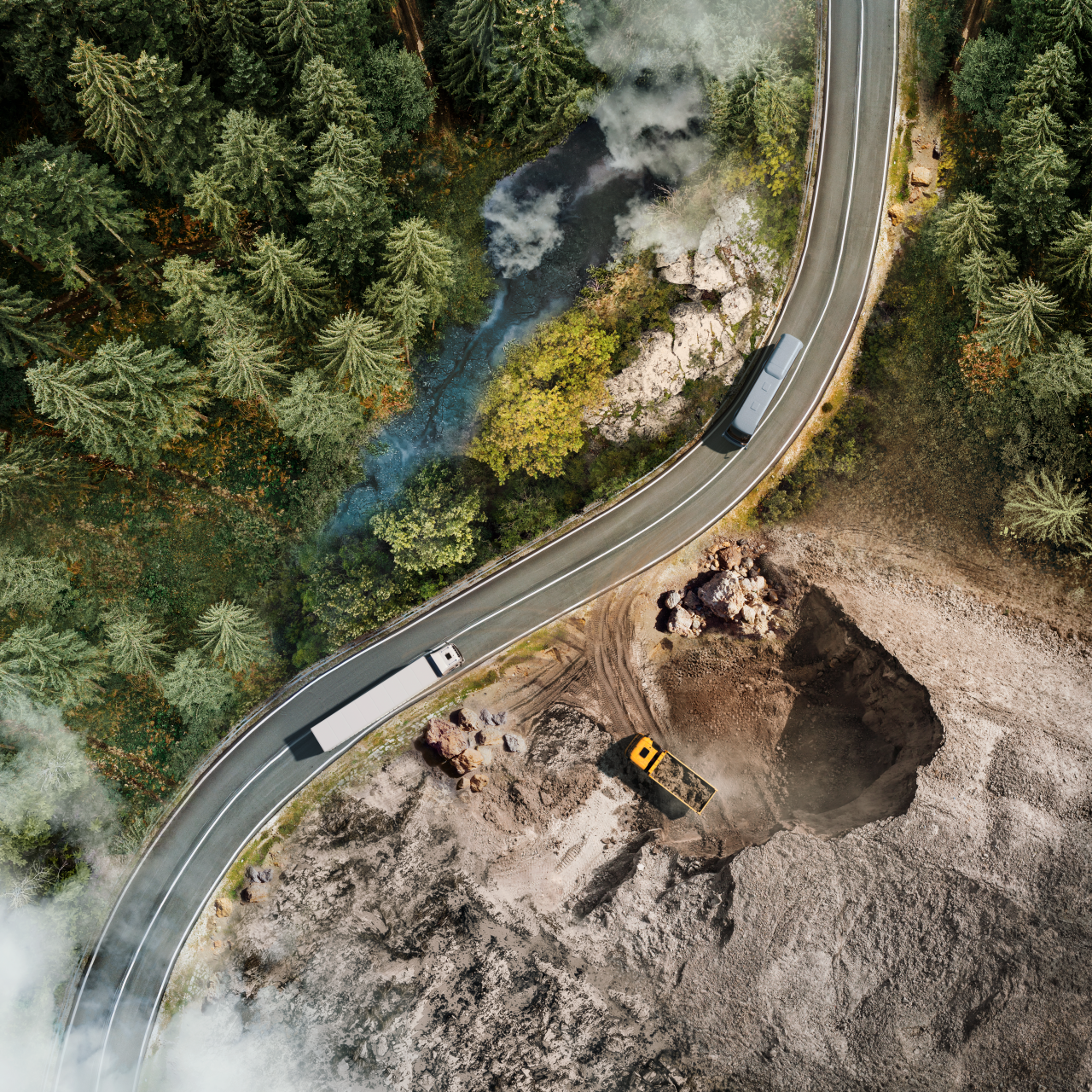 Aerial view of a road crossing a forest and construction site.
