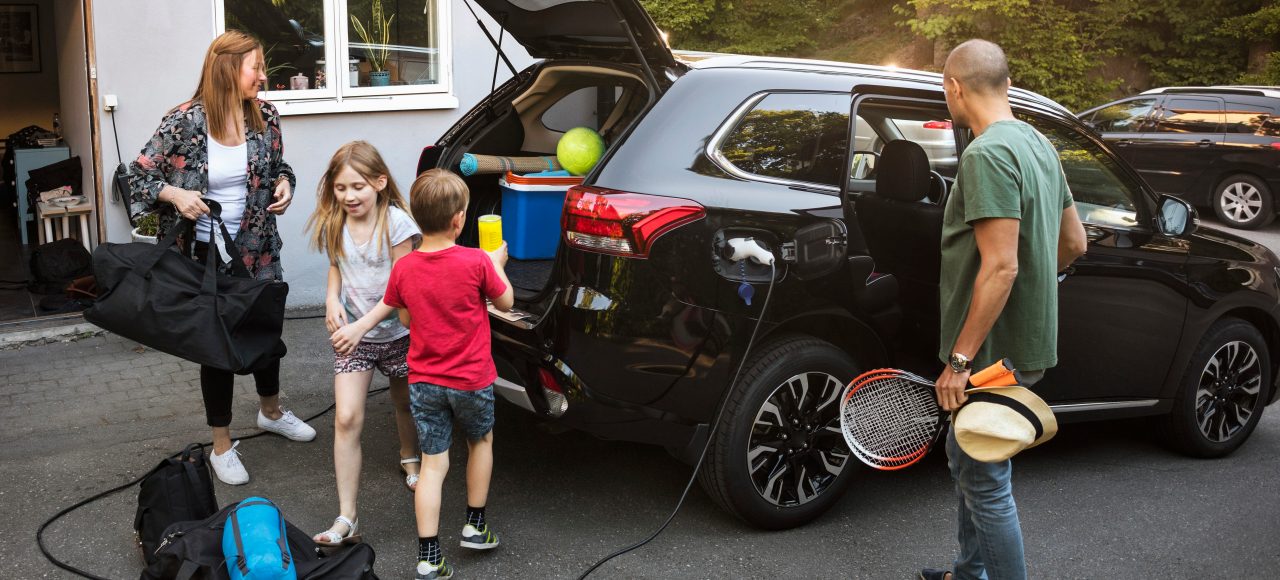 A family is loading their car, ready for holidays.