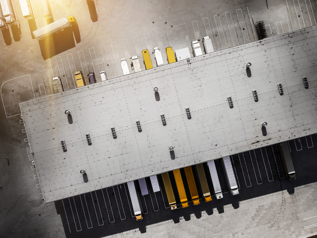 Aerial view of warehouse loading trucks