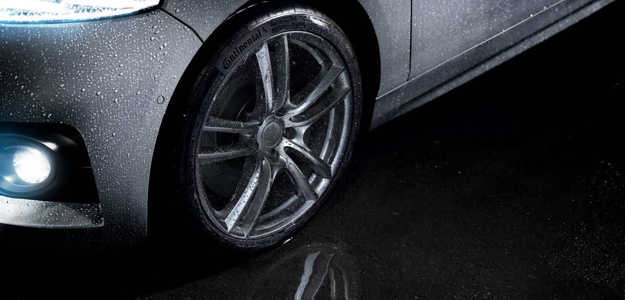 Continental Tire shown in a puddle while it is raining.