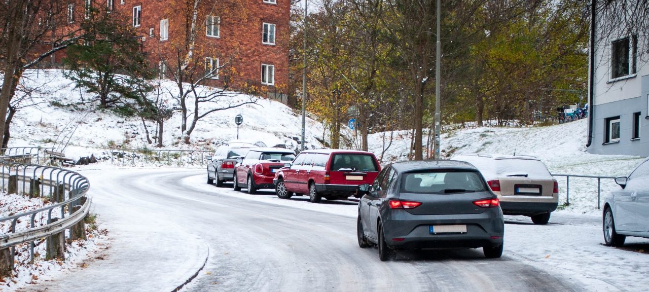 A car on a winter road in the city.