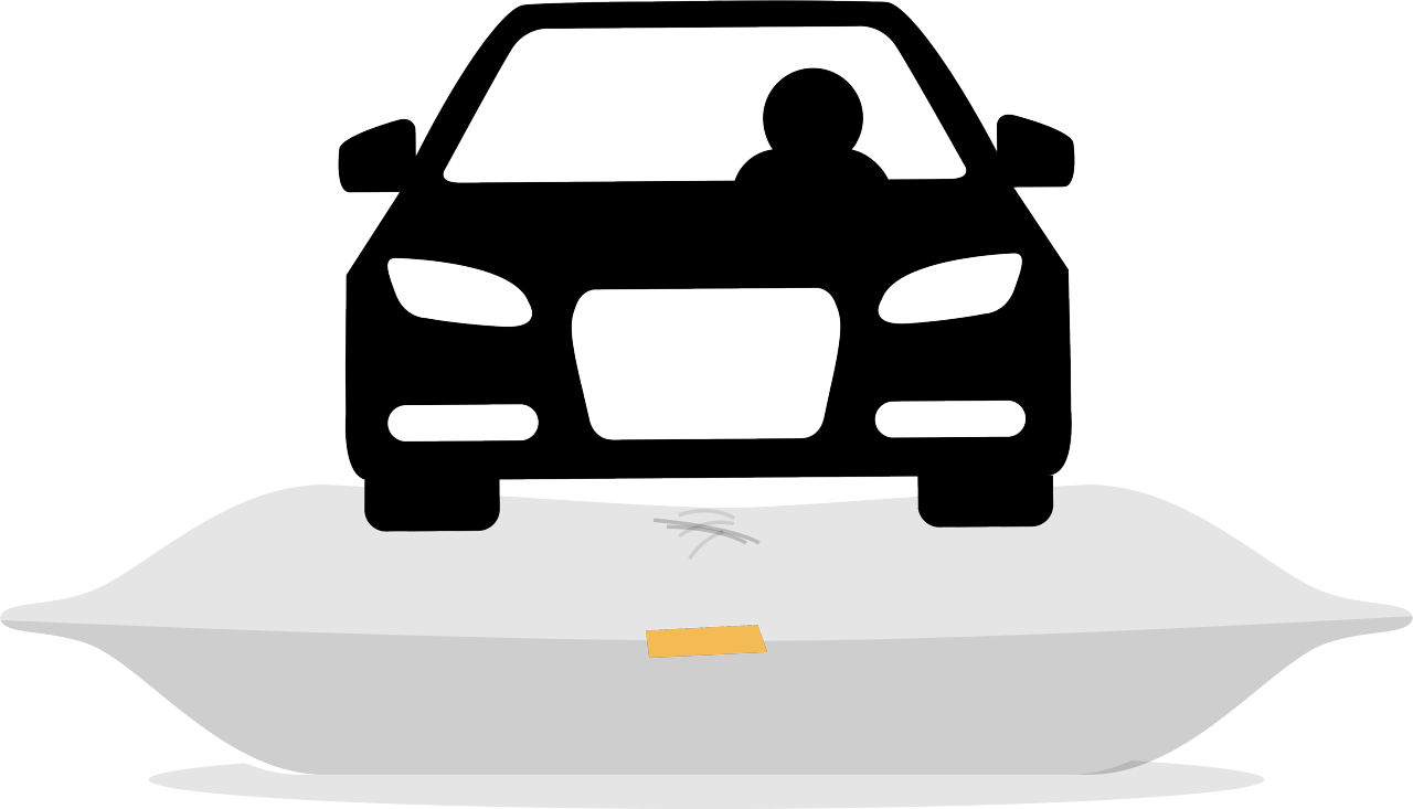 A car drives over a pillow.