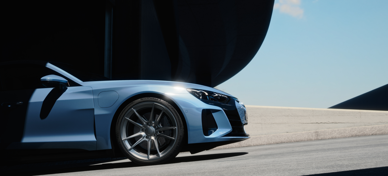 A blue sports car driving on a road