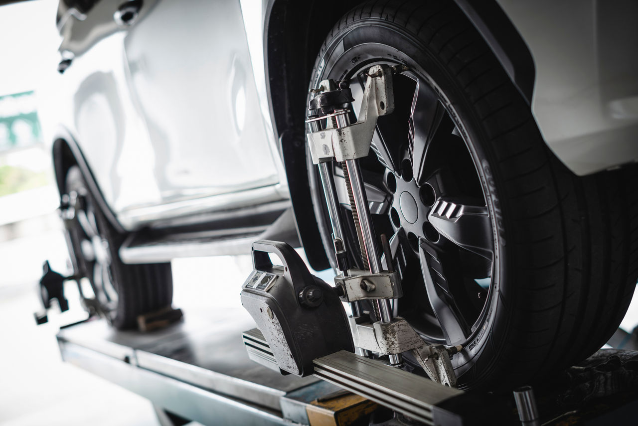 Wheel6 Car wheel alignment services in garage service shop.