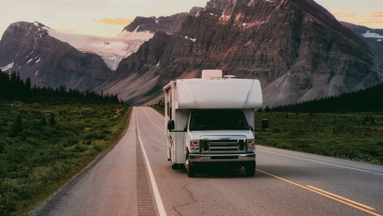 A class C RV driving down the road